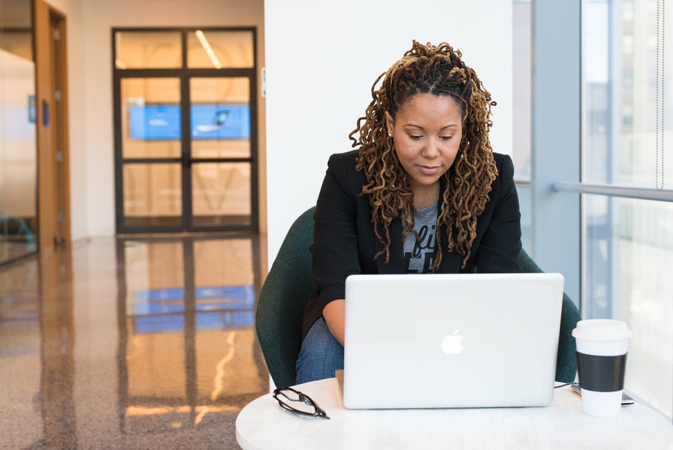 A woman using her laptop in an office setting