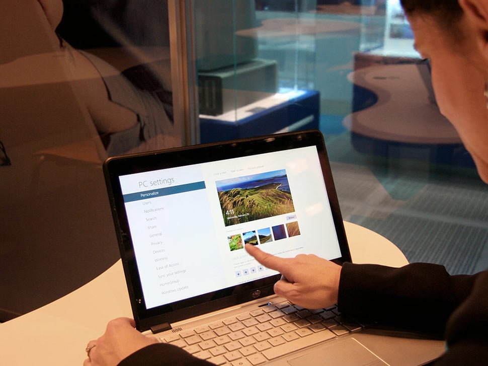 A person using a computer to conduct user testing.  An office setting in the background.