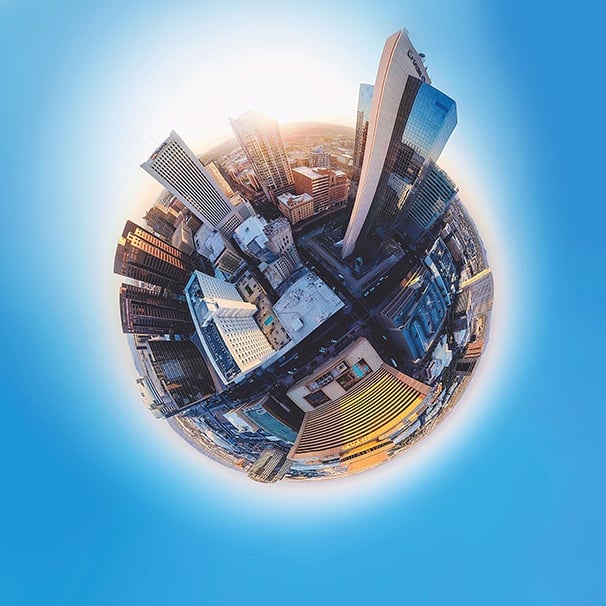 View of a city in a circle surrounded by blue background.